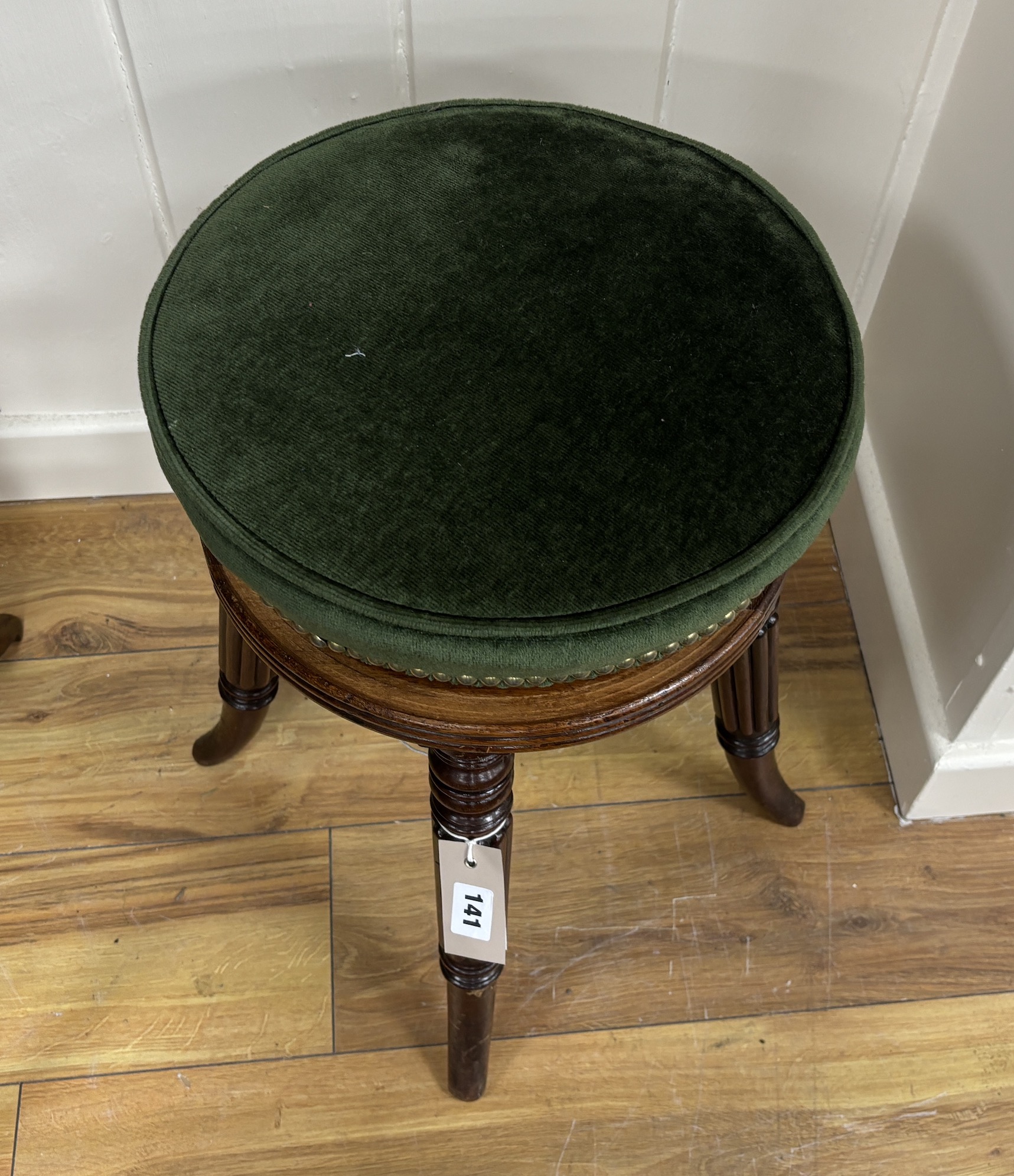 A Regency mahogany revolving adjustable piano stool